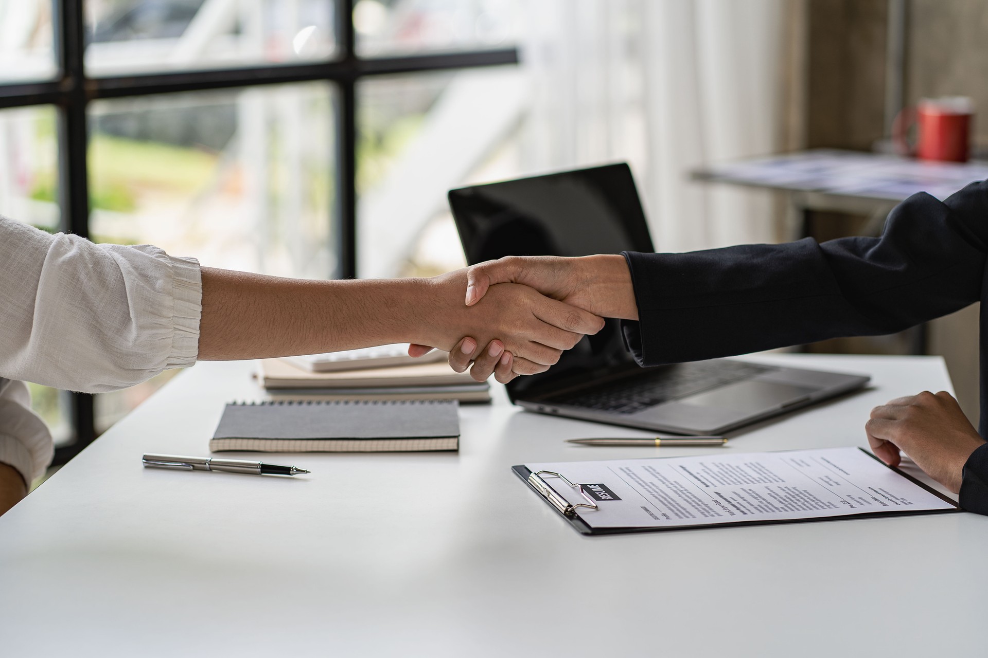 Human Resources Managers shake hands with job seekers to welcome candidates for vacancies. Manager, good positive first impression.